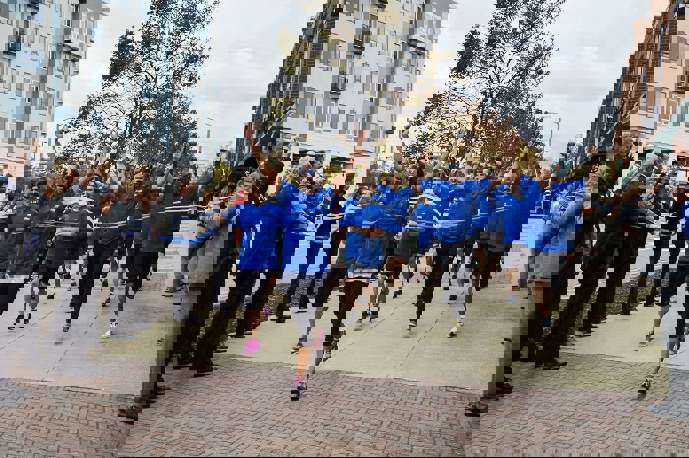 Marathon Consulting team running through finish line